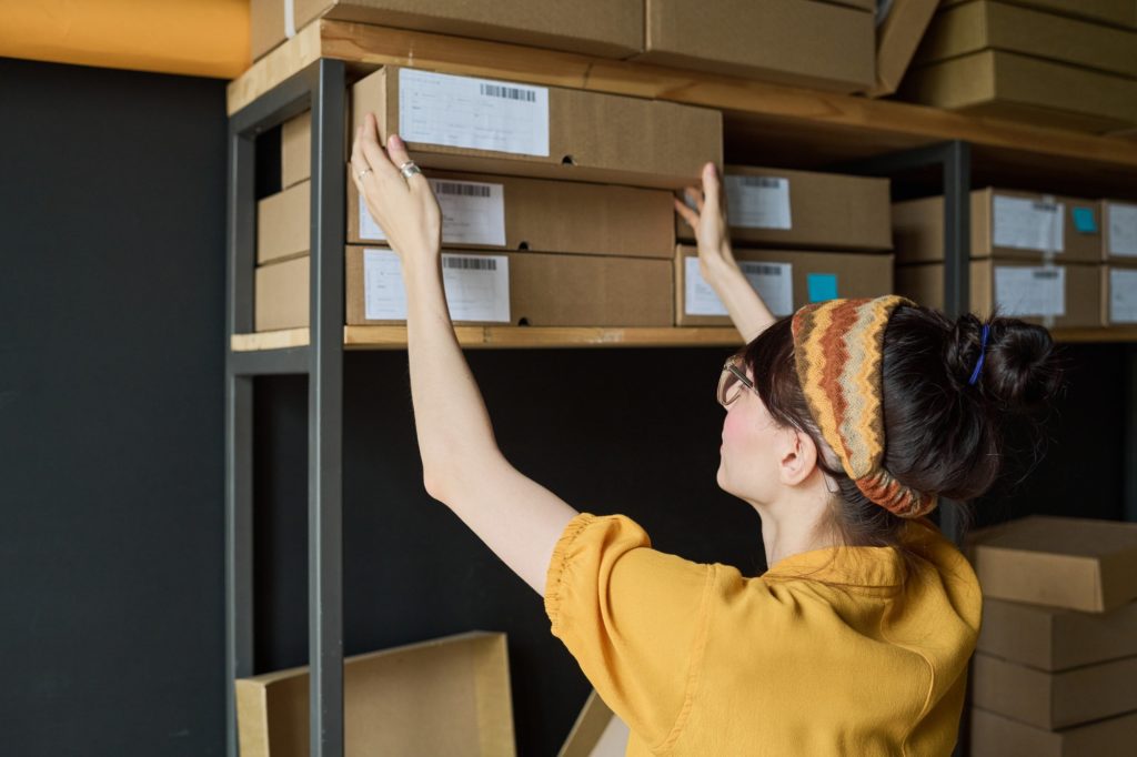 Worker working with parcels in storage room